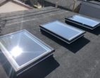 Three glass unit skylights on a residential roof