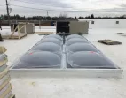 Bronze Acrylic Dome Butted Skylights on a White Reflective Roof