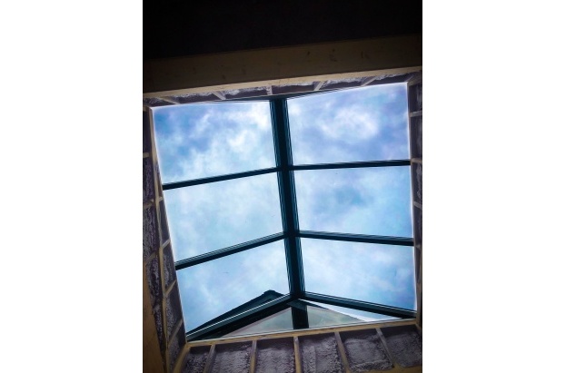glass pyramid skylight with matte black framing clear glass vertical ends