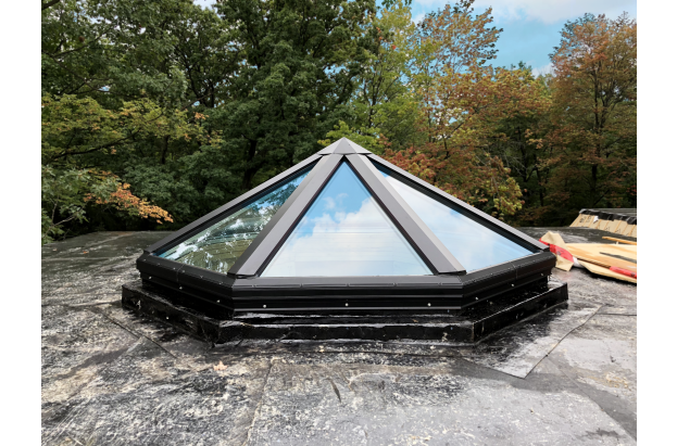 Glass pyramid skylight on a flat roof
